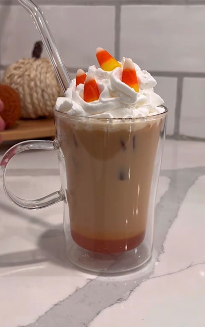 A TikToker makes a Halloween coffee drink at home, the candy corn latte. 
