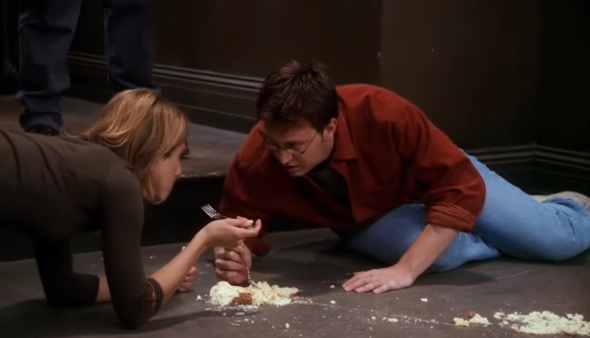 Chandler (Matthew Perry) and Rachel (Jennifer Aniston) eat cheesecake off the hallway floor in 'Frie...
