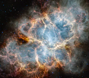 An oval nebula with a complex structure against a black background. On the oval's exterior lie curta...