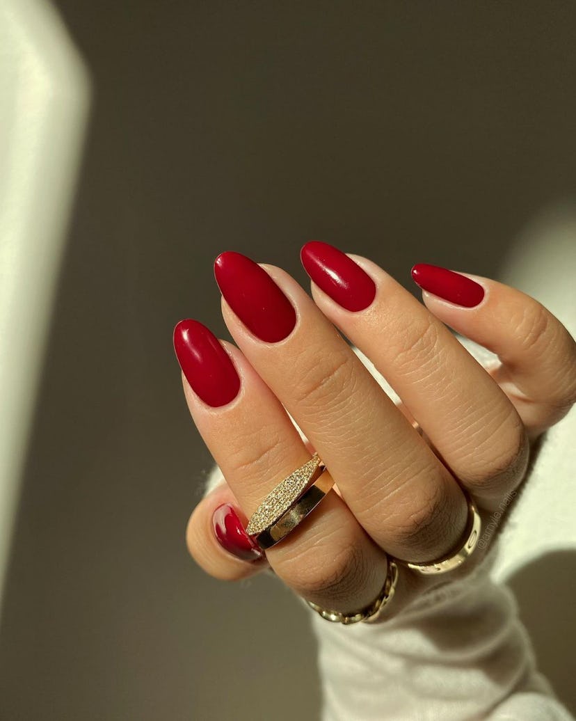 One of the most popular winter nail polish color trends for 2024 is classic cherry red.
