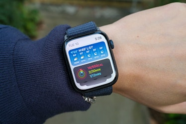 An Apple Watch Series 9 on a wrist with the Smart Stack interface from watchOS 10 visible.