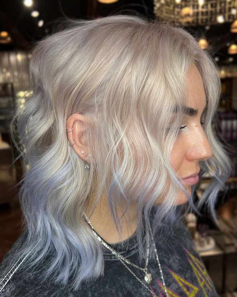 Pops of icy blue are a popular winter hair color trend for 2024.