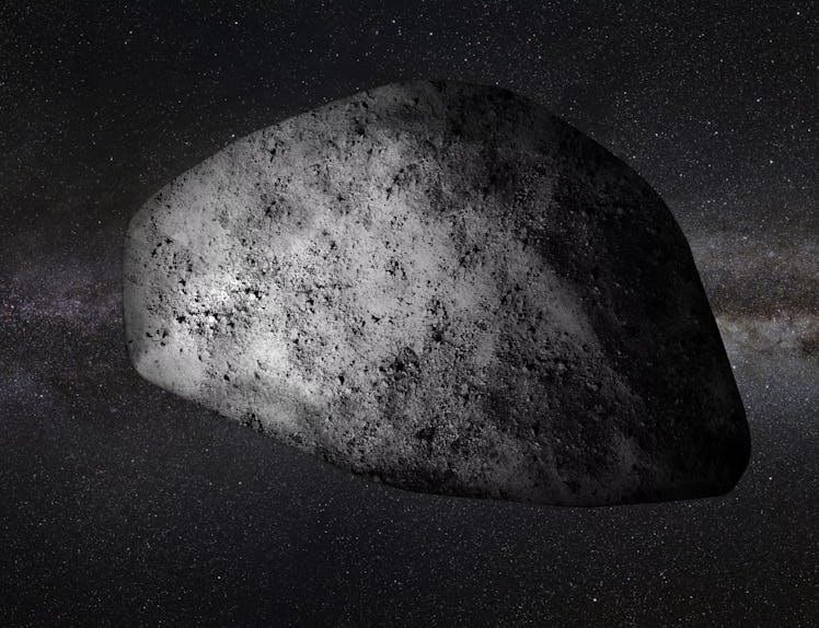 The rough side of a stony asteroid is illuminated, while its right edge is shadowy. The band of the ...