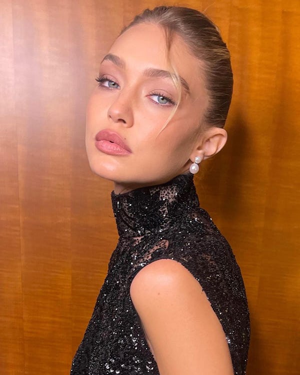 Gigi Hadid's French roll hairstyle was created by Dimitris Giannetos for Miu Miu's Paris Fashion Wee...