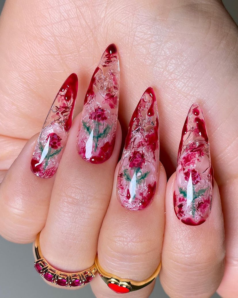 If you need ideas for vampire nails for Halloween 2023, try a trendy clear & red rose blood splatter...