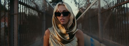 Miley Cyrus in the "Flowers" music video wearing an Yves Saint Laurent dress