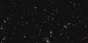 The striking, velvety black canvas of space is adorned with bright sparkling specks. They're scatter...