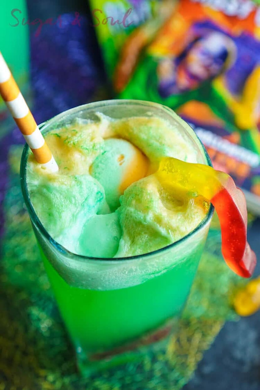 Goosebumps punch is an easy Halloween mocktail, a green sherbet based drink in a glass with a gummy ...