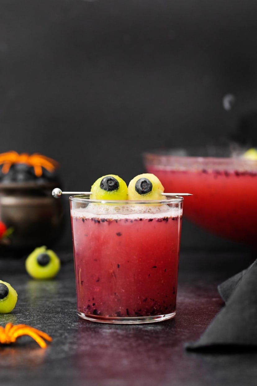 Halloween mocktails, like this berry punch with green grape eyeball garnish, are great for kids and ...