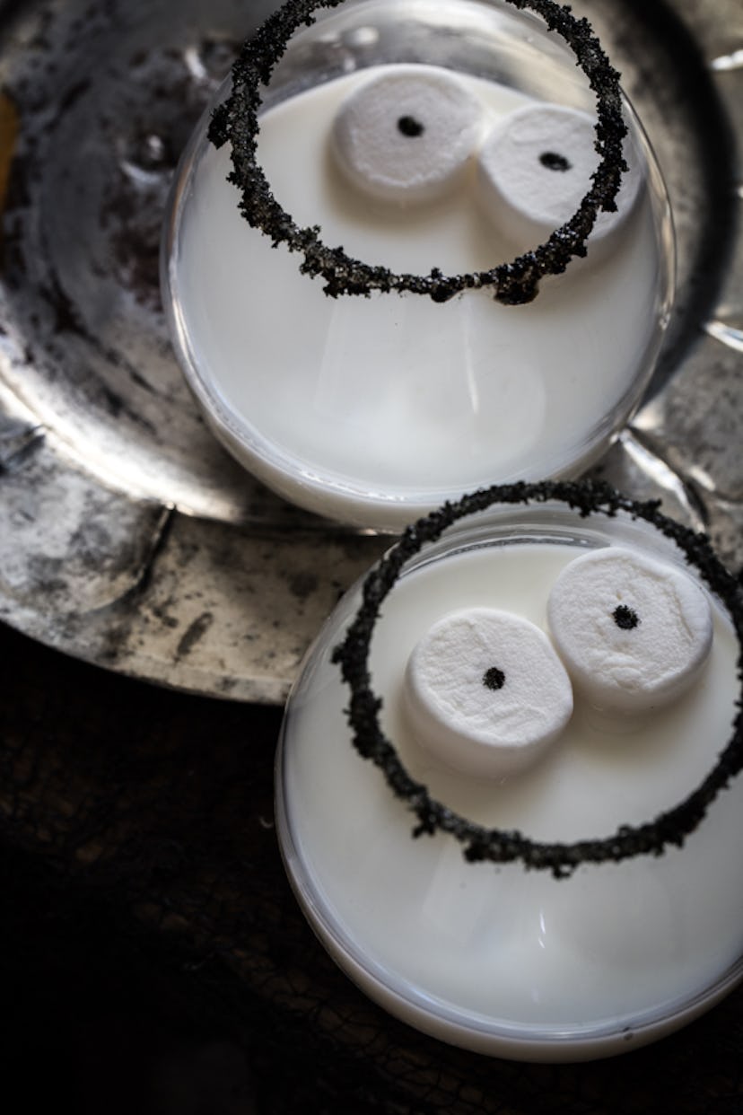 Easy Halloween cocktail, a white drink with marshmallow eye garnish