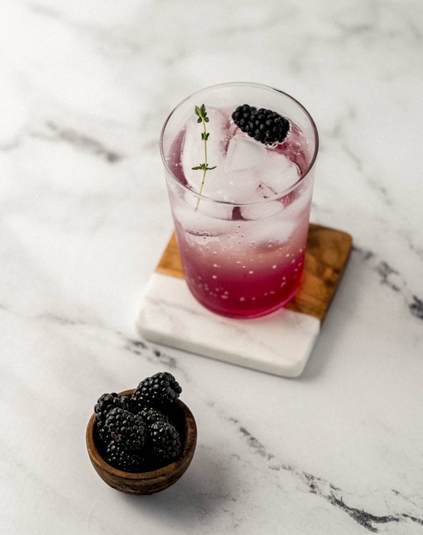 A blackberry thyme spritz that would make a great Halloween mocktail in a skull glass or with a fun ...