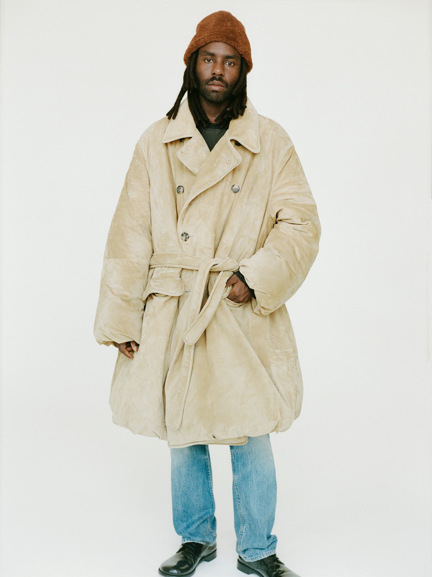 Dev Hynes in trench coat. 