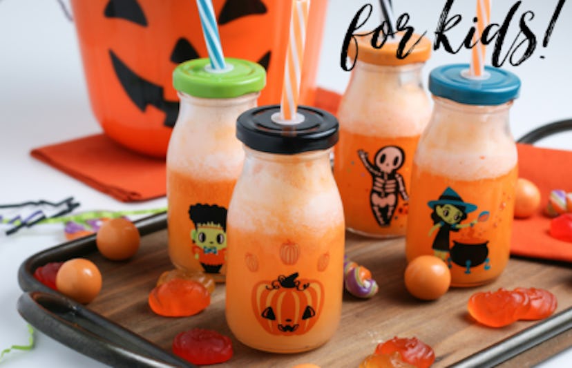 Orange Halloween mocktail in holiday milk bottles for kids.