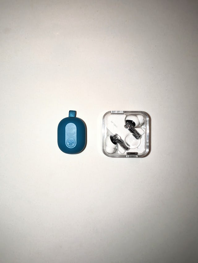 Jlabs Jbuds Mini earbuds next to a Nothing's Ear 2 Wireless Earbuds