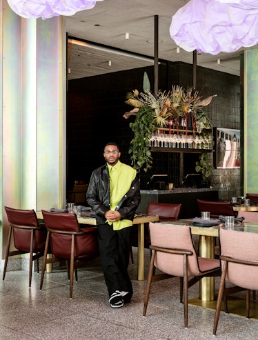 Kwame Onwuachi Chef wears a lime green button-down shirt, black pants, leather jacket and Jordan 1 s...