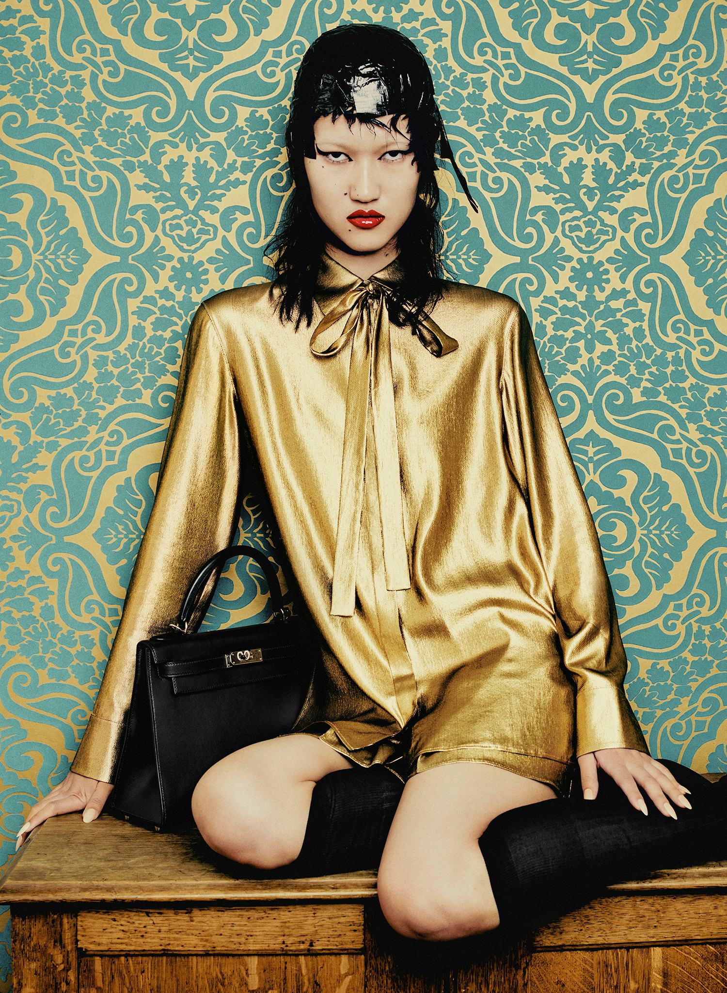 Toktorova wears a yellow blouse, sheer socks, skirt and leather bag.