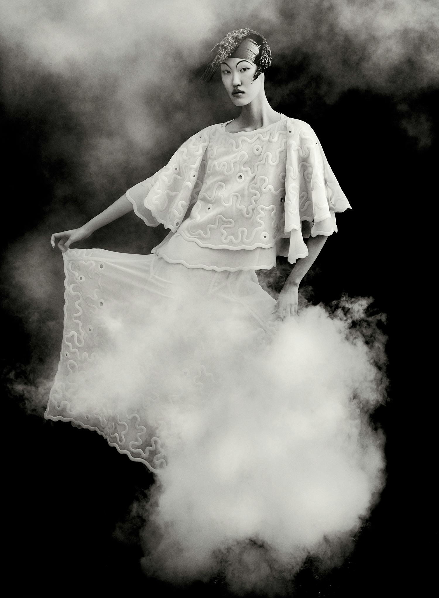 Kim Seung Ri wears white dress and cape.