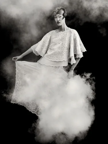Kim Seung Ri wears white dress and cape.