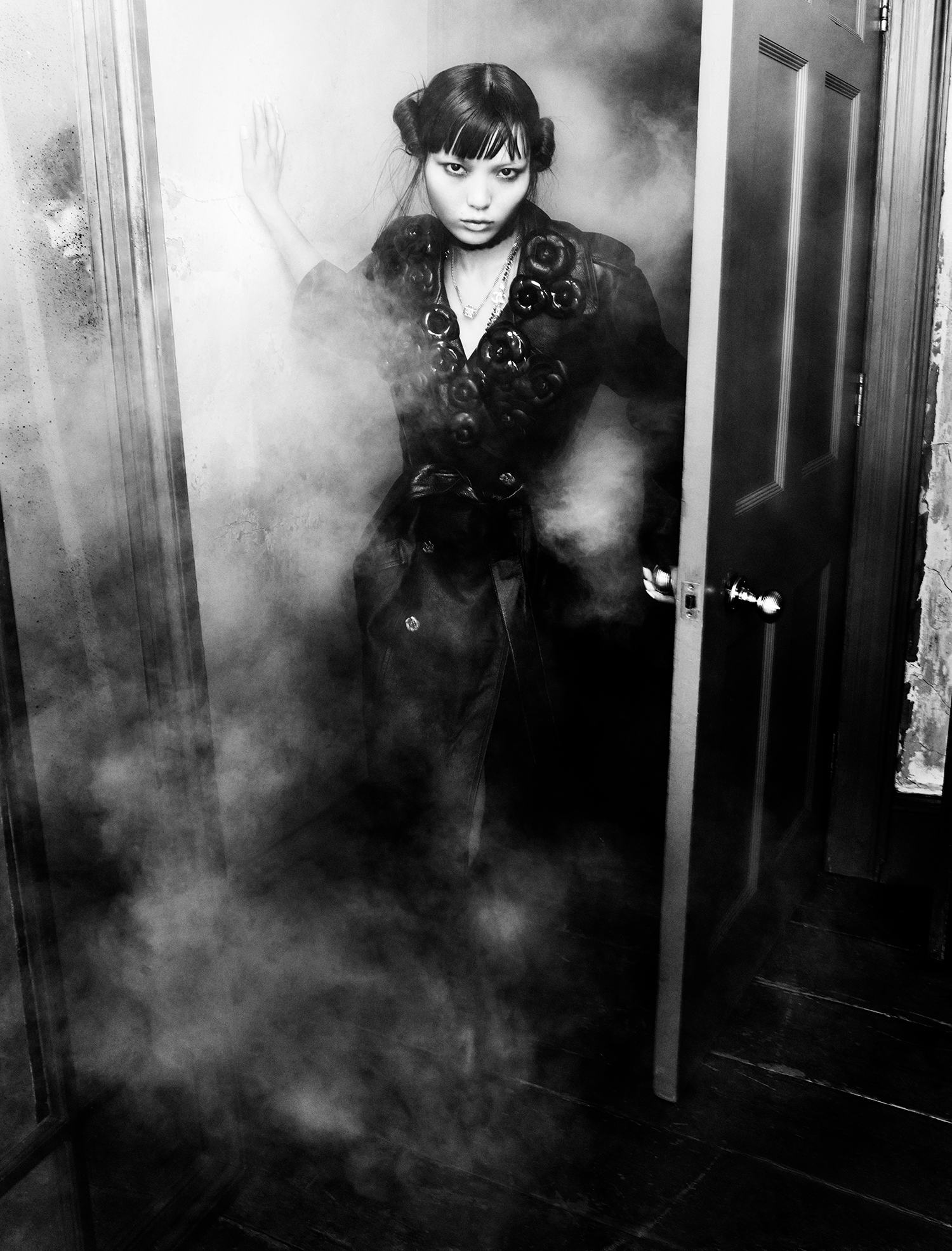 Lian Jia wears a leather coat, necklaces and boots.