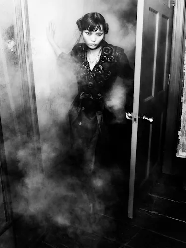 Lian Jia wears a leather coat, necklaces and boots.