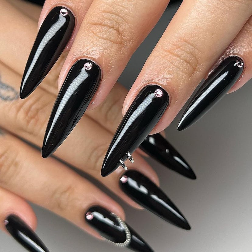 If you need ideas for vampire nails for Halloween 2023, try simple black stiletto nails with silver …