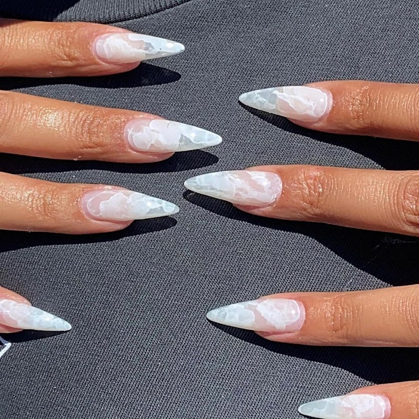 If you need ideas for vampire nails for Halloween 2023, try a white marble nail design on stiletto-s...
