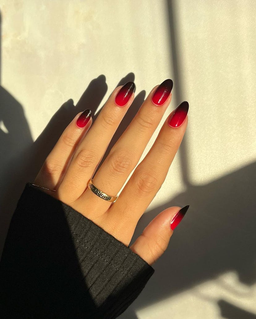 If you need ideas for vampire nails for Halloween 2023, try a simple black & red gradient ombre nail...