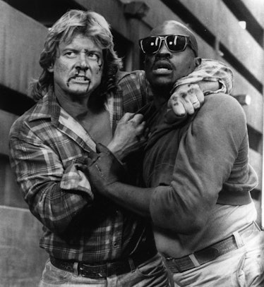 Keith David and Roddy Piper bloodied attempt to overcome alien forces in a scene from the Universal ...