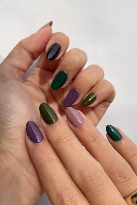 Skittle nails with muted, dark academia-inspired nail polish colors matches the trending aesthetic.