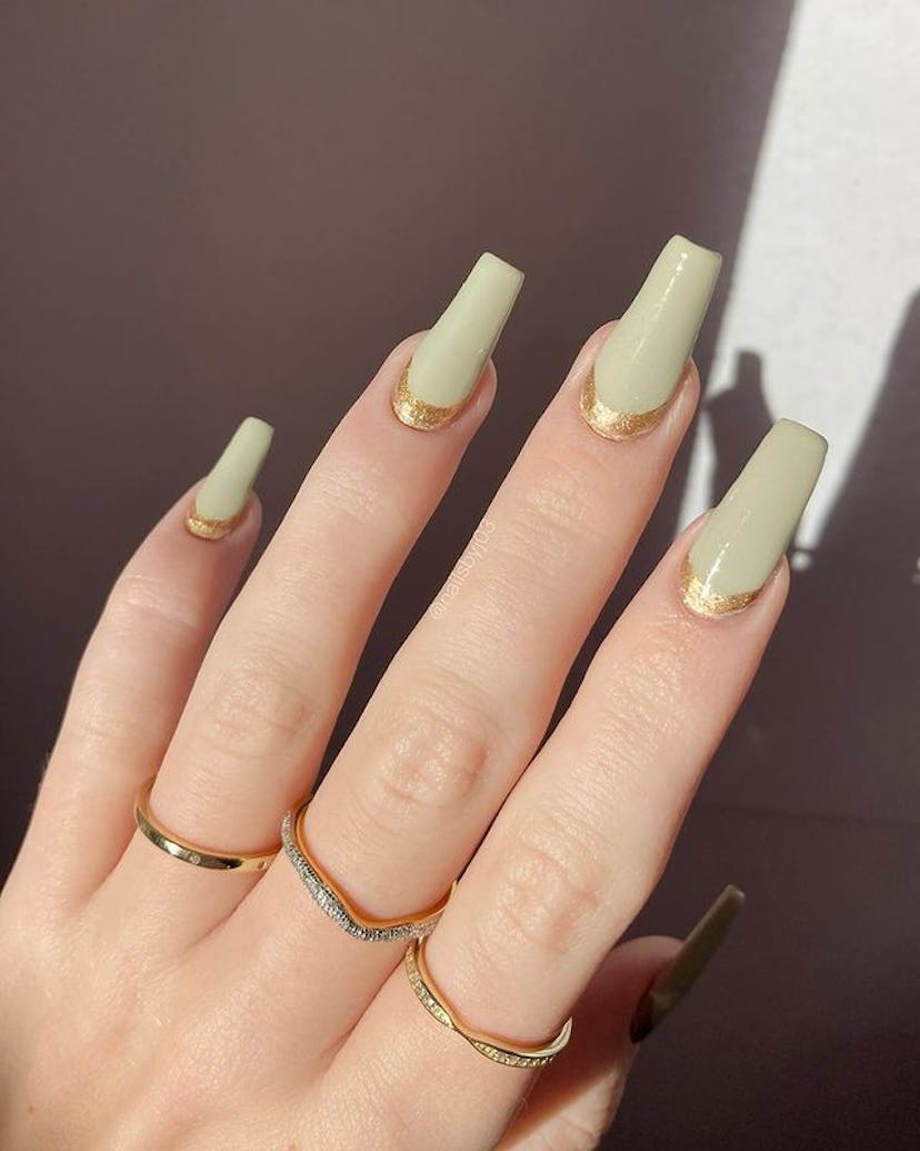 Green nails with gold detail.