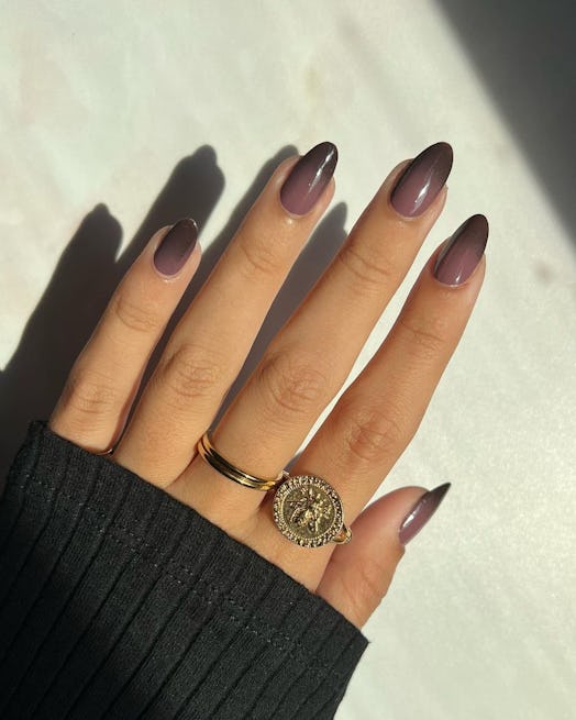 Gradient nails with muted purple and charcoal grey polish colors match the dark academia aesthetic.