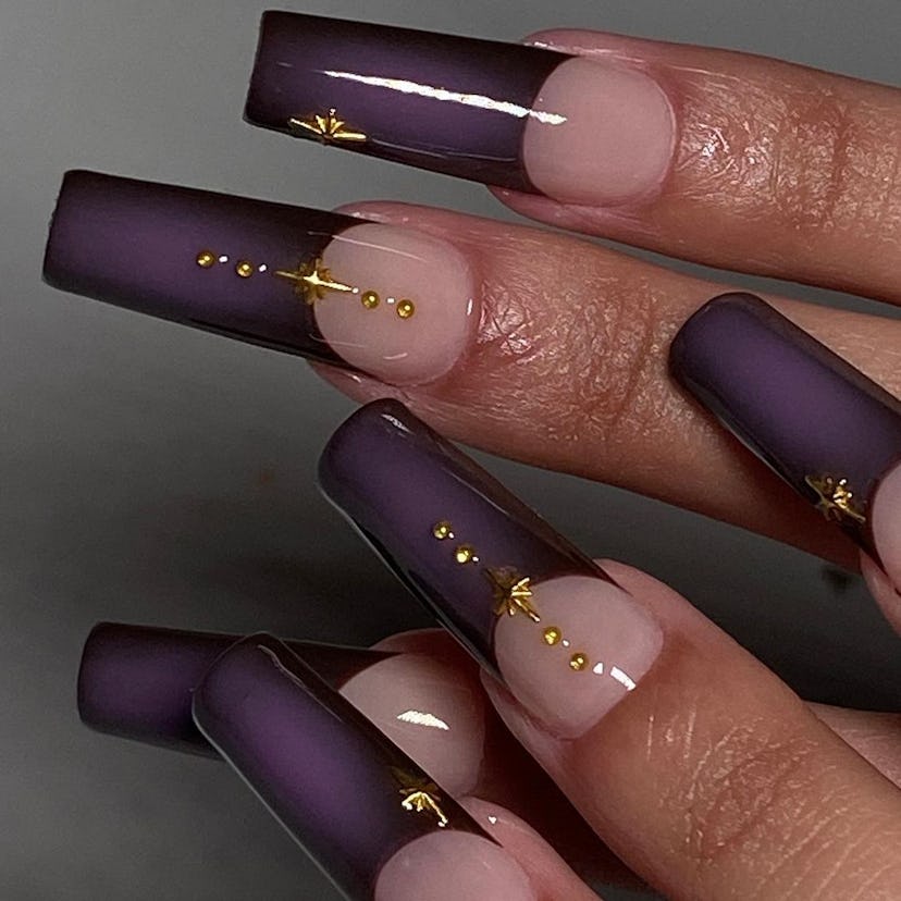 Dark purple aura French nails with golden details match the dark academia aesthetic.