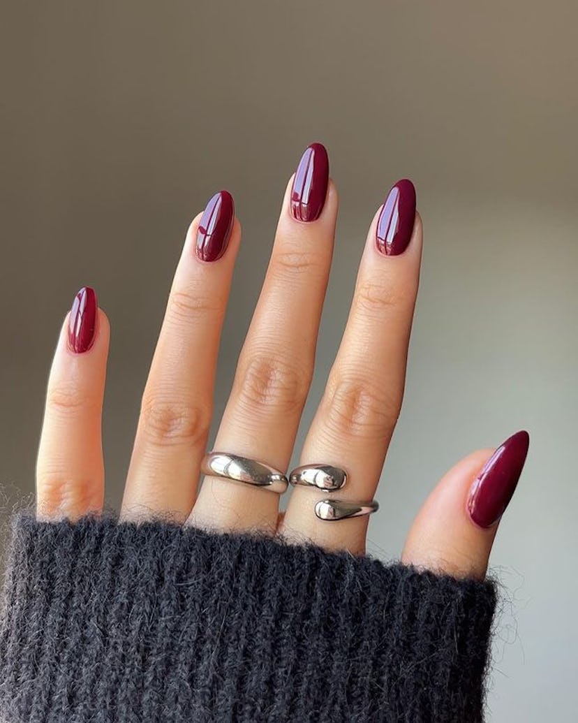Burgundy red nails.