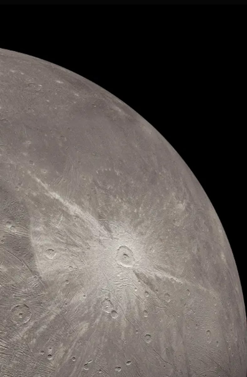A grayscale moon with a cracked icy surface on a black background