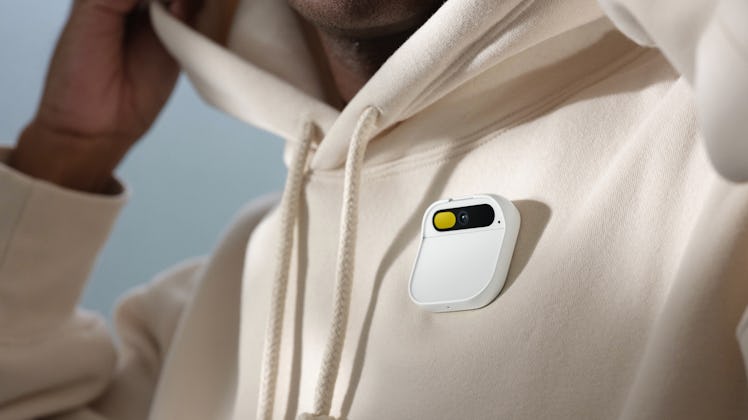 The Ai Pin attached to a white jacket.