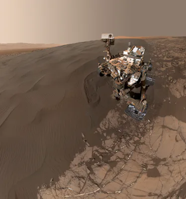 The slope of a dark, richly-colored dune covers three-fourths of the terrain. Curiosity, standing at...