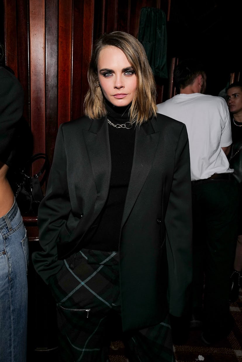 Cara Delevigne poses at Burberry party