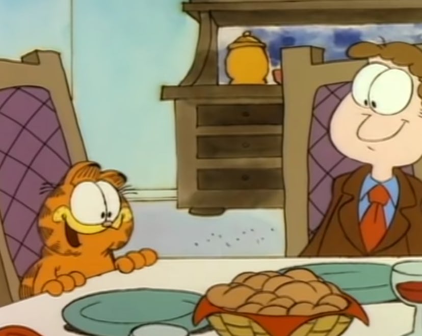 Garfield and Jon at the Thanksgiving table in 'Garfield's Thanksgiving.'