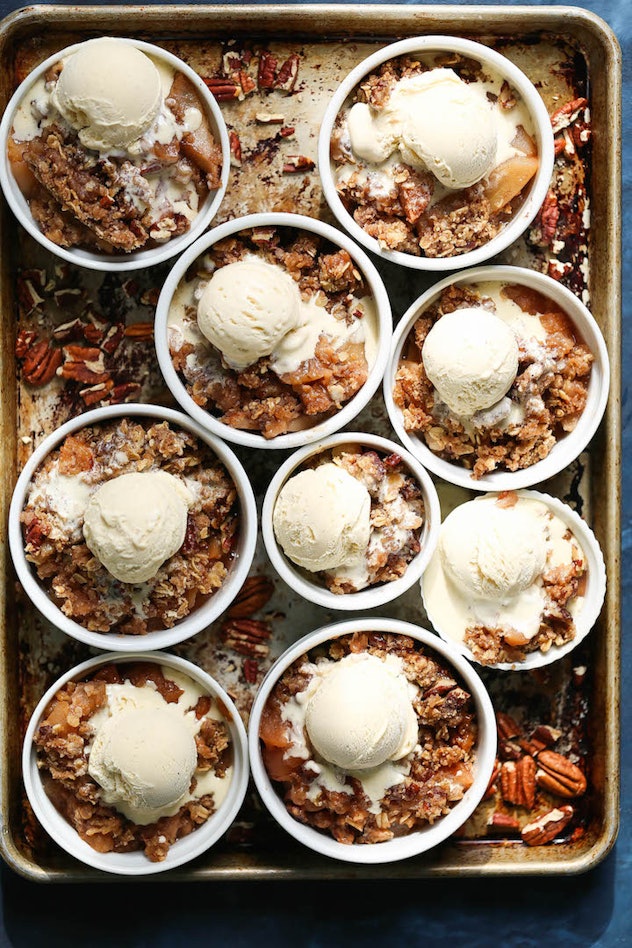 Ramekins of apple crisp topped with ice cream, a fall dessert for Thanksgiving that isn't pie.