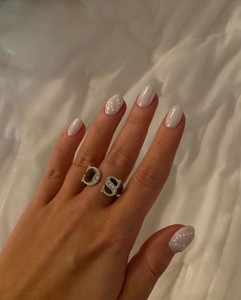Sabrina Carpenter's chrome nails with a heart pearl design for Taylor Swift's Eras Tour in Nov. 2023...
