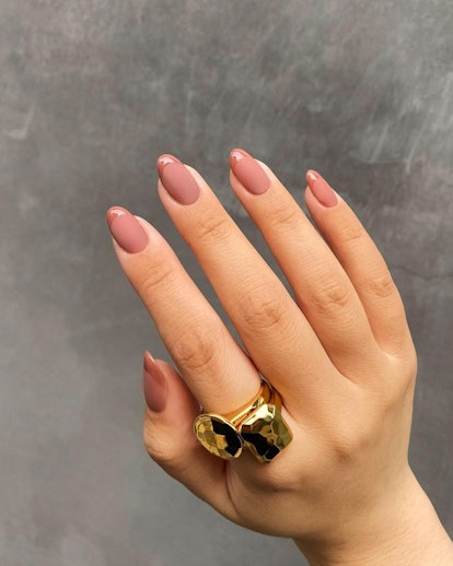 Glossy-tipped milk chocolate French tips are an on-trend Thanksgiving nail design for 2023.