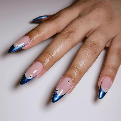 Blue chrome French tip nails with 3D details are on trend for winter 2024.