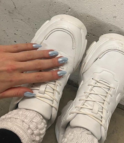 Light blue chrome nails are a popular manicure trend for winter 2024.