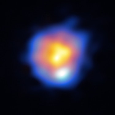 a star in shades of orange, surrounded by blue gas, on a black background