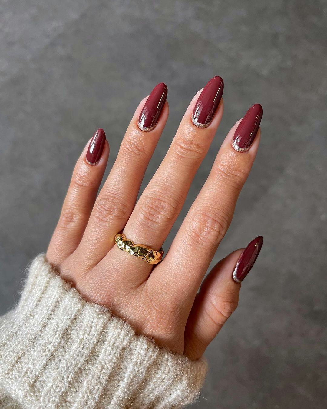&ldquo;Cherry mocha&rdquo; nails with glitter cuffs are an on-trend Thanksgiving nail design 2023.