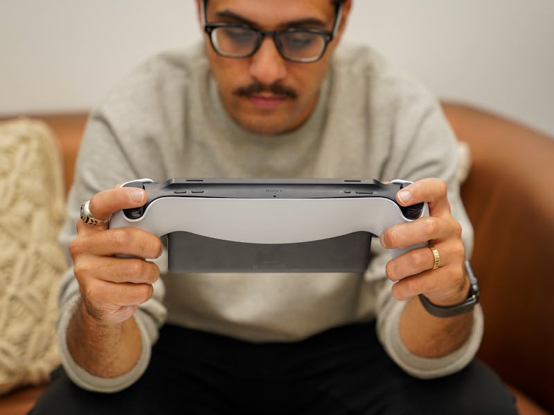 A man playing with the Sony PlayStation Portal