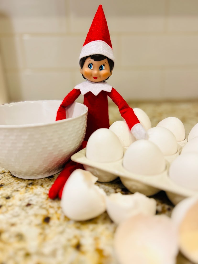 elf on the shelf next to some eggs