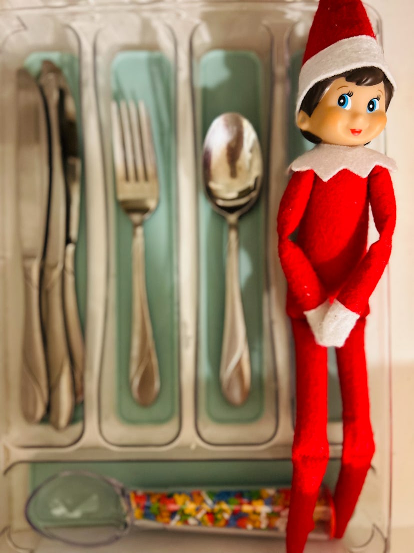 elf on the shelf doll in a utensil holder