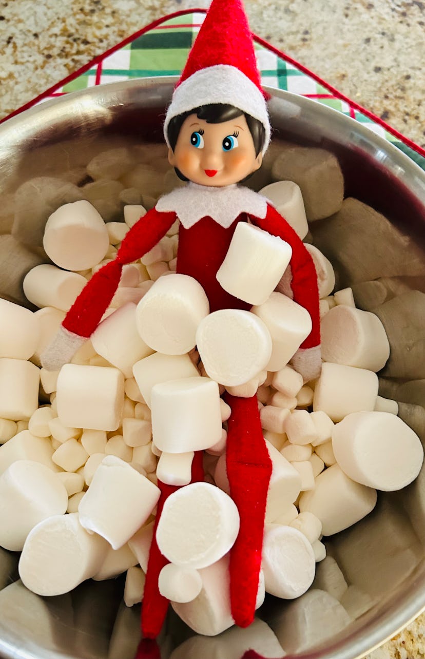 elf on the shelf taking a bath in a bowl of marshmallows
