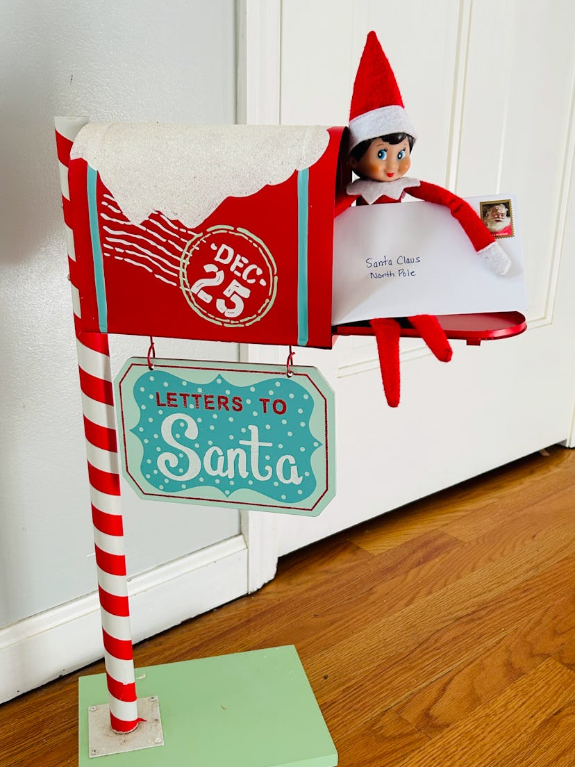 elf on the shelf mailing a letter to Santa Claus 